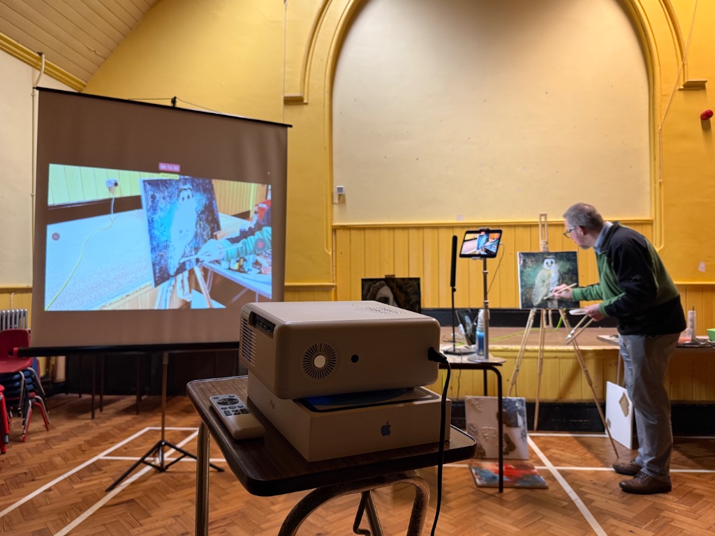 Surrey art group demonstration showing Ian Wilson Pope painting live with projector setup