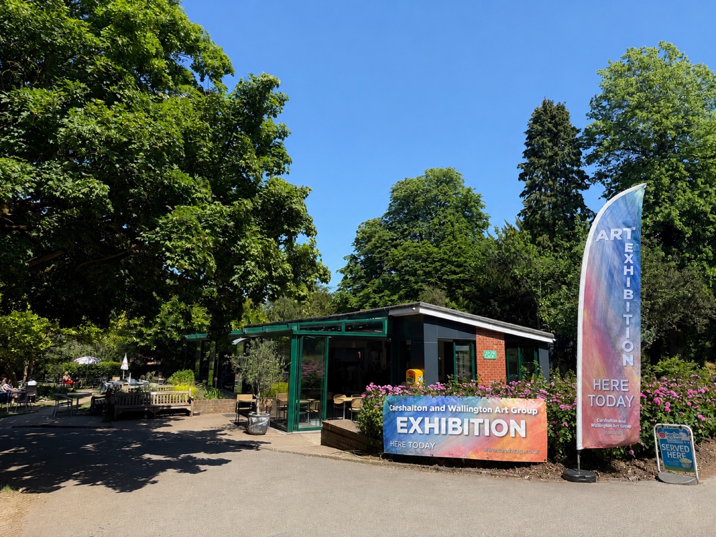 Oaks Park Café in Banstead displaying CandWAG art exhibition signs